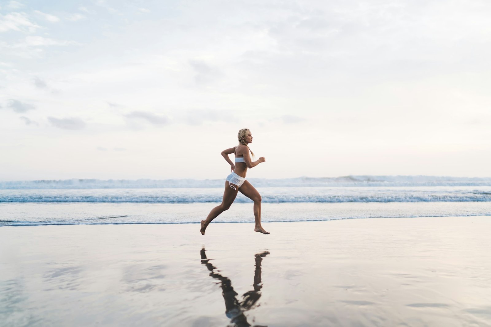 Runner moves on ocean beach